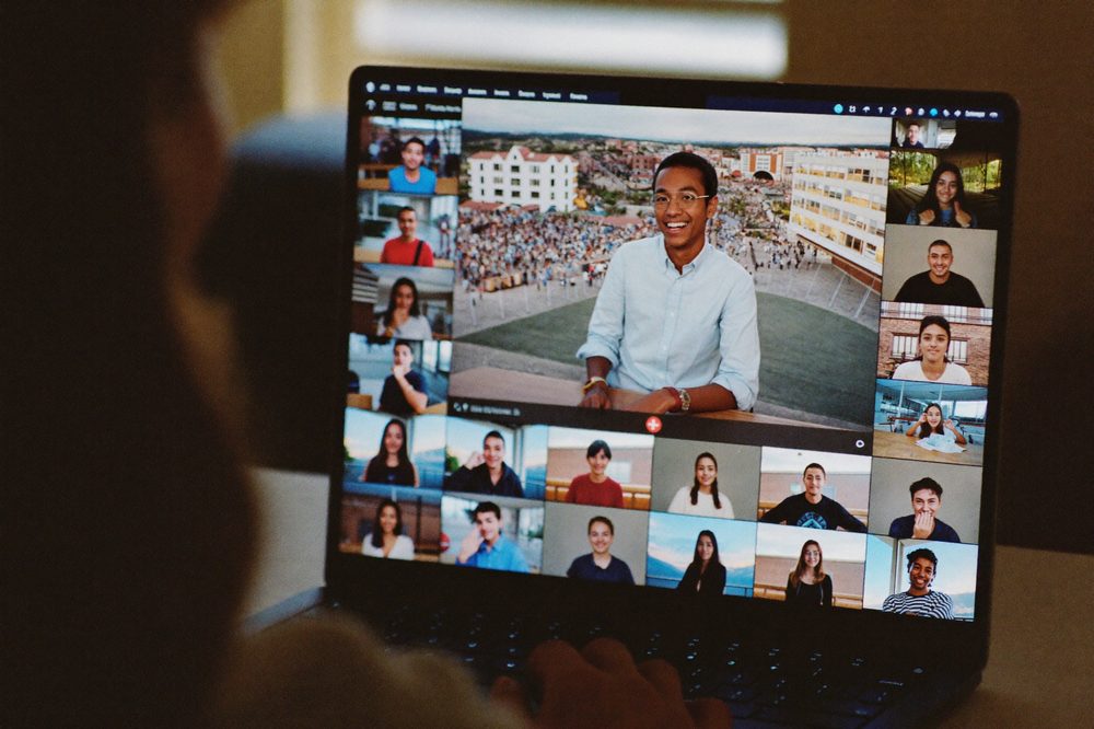 A student ambassador presents a 360-degree campus tour on a video call with dozens of participants